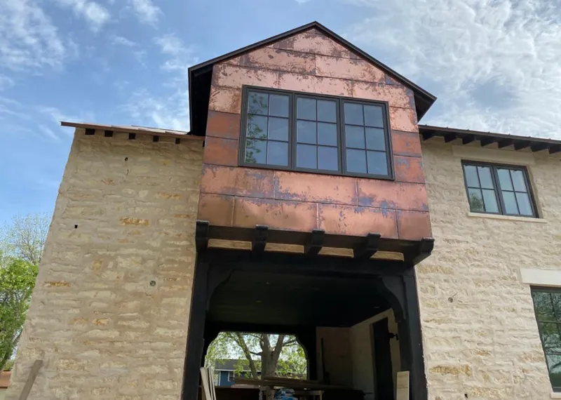 Copper metal panel facade on a stone building for Skylight Installation in Bay City